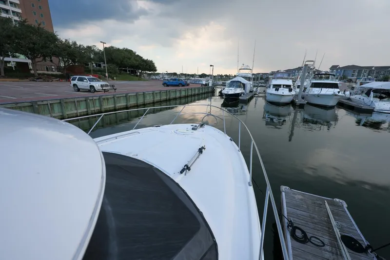 My Gypsy Soul Yacht Photos Pics 2004 Meridian 411 Sedan docked at a marina with other boats under a cloudy sky.