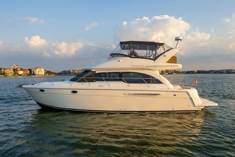 My Gypsy Soul Yacht Photos Pics 2004 Meridian 411 Sedan yacht cruising on calm waters at sunset.