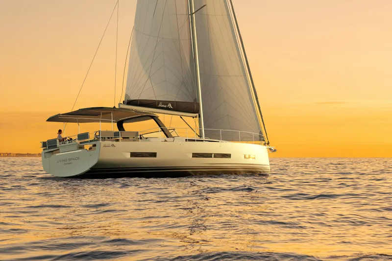  Yacht Photos Pics Sailing yacht Hanse 590, 2026 model, at sunset on calm ocean waters.