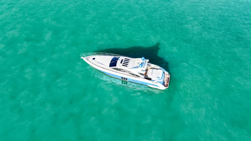  Yacht Photos Pics Aerial view of a 2006 Azimut 68S yacht on turquoise water.