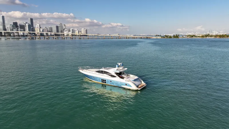  Yacht Photos Pics Luxury 2006 Azimut 68S yacht cruising near city skyline on calm waters.