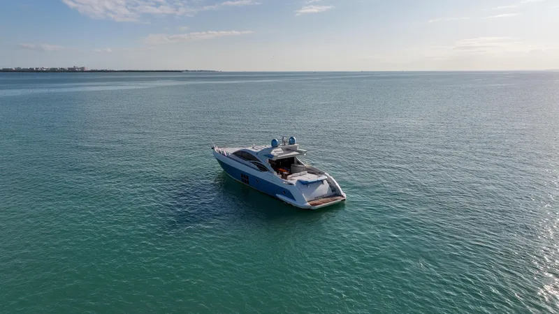  Yacht Photos Pics Azimut 68S yacht from 2006 on calm ocean waters under a clear sky.