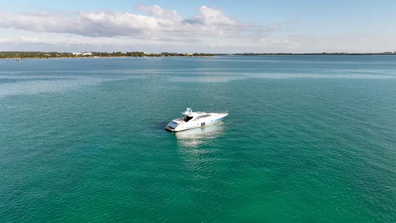  Yacht Photos Pics 2006 Azimut 68S yacht on calm turquoise waters under a partly cloudy sky.