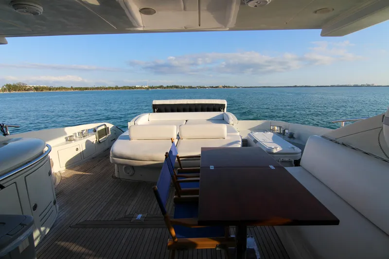  Yacht Photos Pics Luxurious 2006 Azimut 68S yacht deck with seating, table, and ocean view.