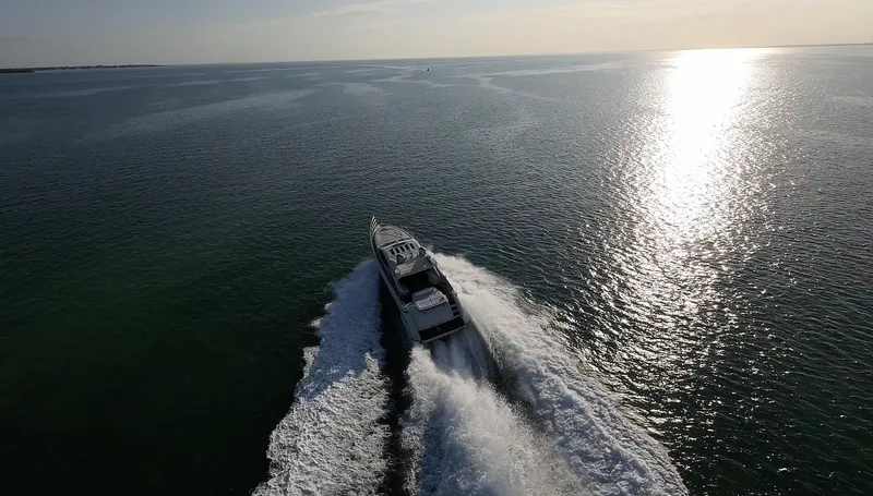  Yacht Photos Pics Azimut 68S yacht cruising on open water at sunset, 2006 model.