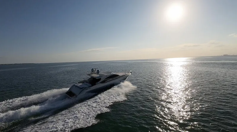  Yacht Photos Pics 2006 Azimut 68S yacht cruising on open water at sunset.