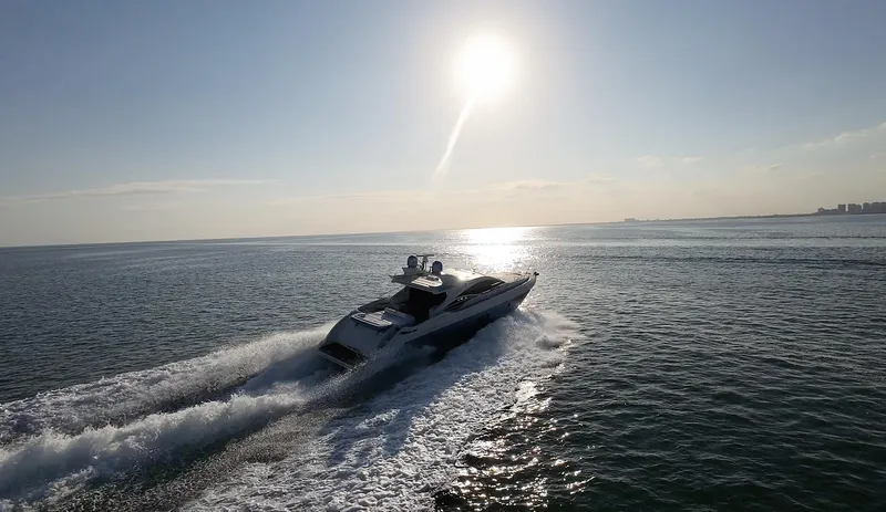  Yacht Photos Pics Azimut 68S yacht cruising on open water at sunset, 2006 model.