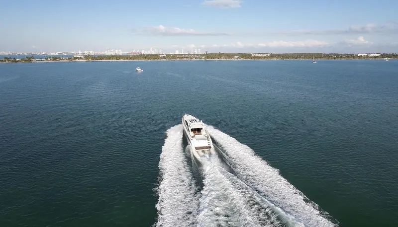  Yacht Photos Pics 2006 Azimut 68S yacht cruising on open water with scenic coastline in the background.