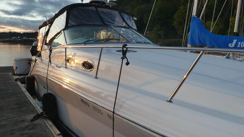  Yacht Photos Pics 2007 Sea Ray 340 Sundancer docked at sunset, reflecting golden light on water.