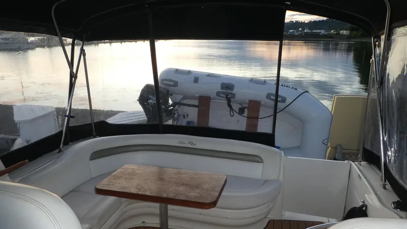 Yacht Photos Pics 2007 Sea Ray 340 Sundancer interior with seating and table, overlooking calm waters.