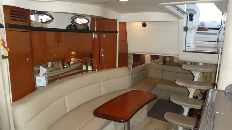 Yacht Photos Pics Luxurious interior of 2007 Sea Ray 340 Sundancer yacht with elegant seating and wooden cabinetry.