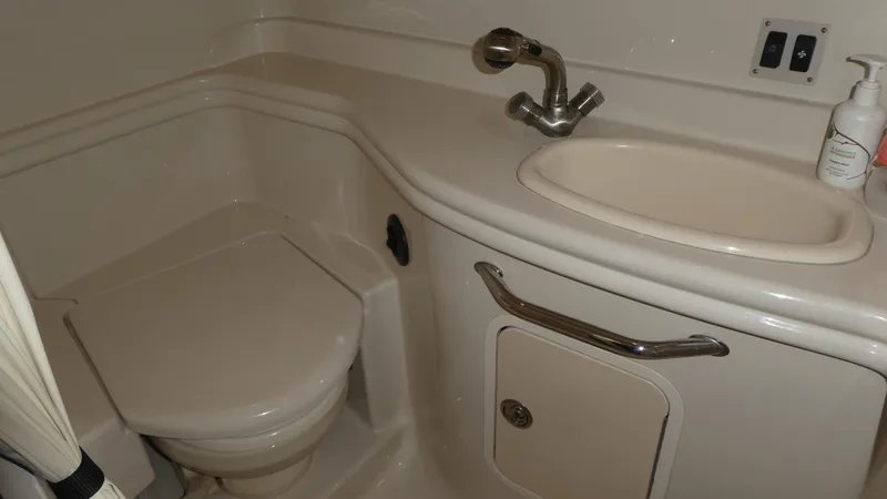  Yacht Photos Pics 2007 Sea Ray 340 Sundancer bathroom with sink, toilet, and storage cabinet.