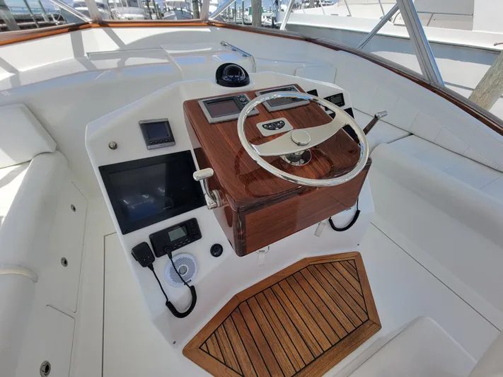  Yacht Photos Pics 2010 Jersey Cape Devil 36 helm station with wooden steering wheel and modern controls.