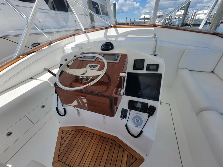 Yacht Photos Pics 2010 Jersey Cape Devil 36 boat helm with wooden accents and modern controls.