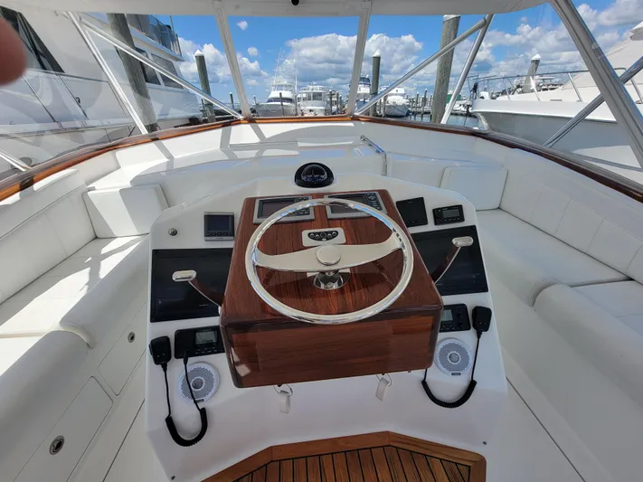  Yacht Photos Pics 2010 Jersey Cape Devil 36 boat helm with wooden steering wheel and white seating.