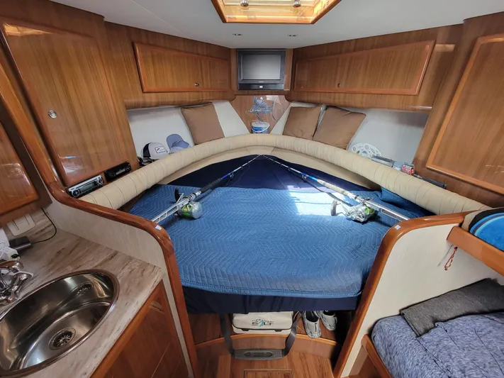  Yacht Photos Pics Interior cabin of 2010 Jersey Cape Devil 36 boat with bed, sink, and TV.