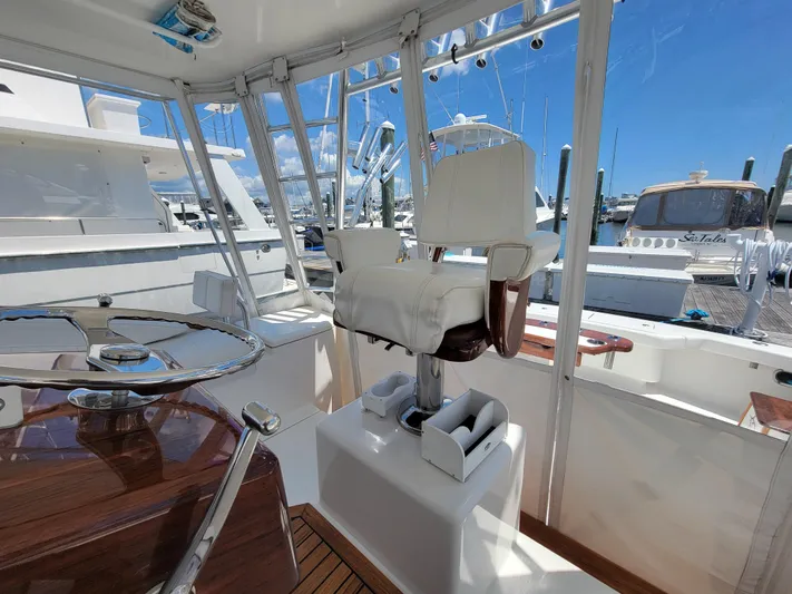  Yacht Photos Pics Interior helm of 2010 Jersey Cape Devil 36 yacht with captain's chair and steering wheel.
