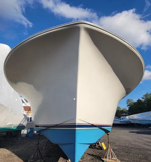  Yacht Photos Pics 2010 Jersey Cape Devil 36 boat on stands under a clear blue sky.