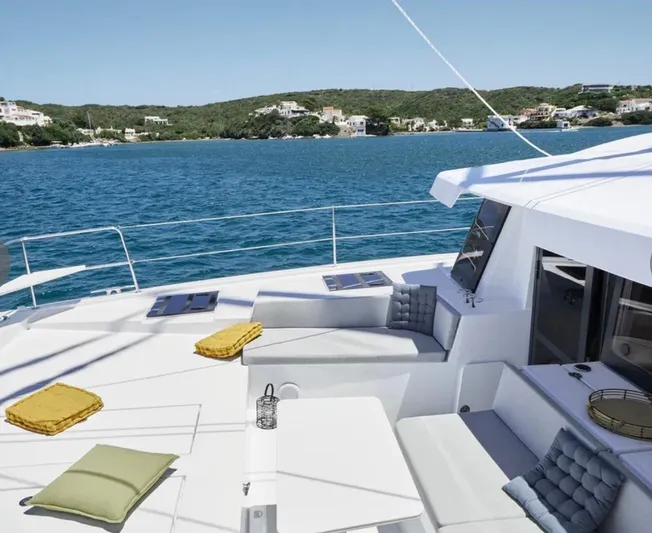  Yacht Photos Pics Luxurious Bali 4.4 catamaran deck with cushions, overlooking serene blue waters, 2023 model.