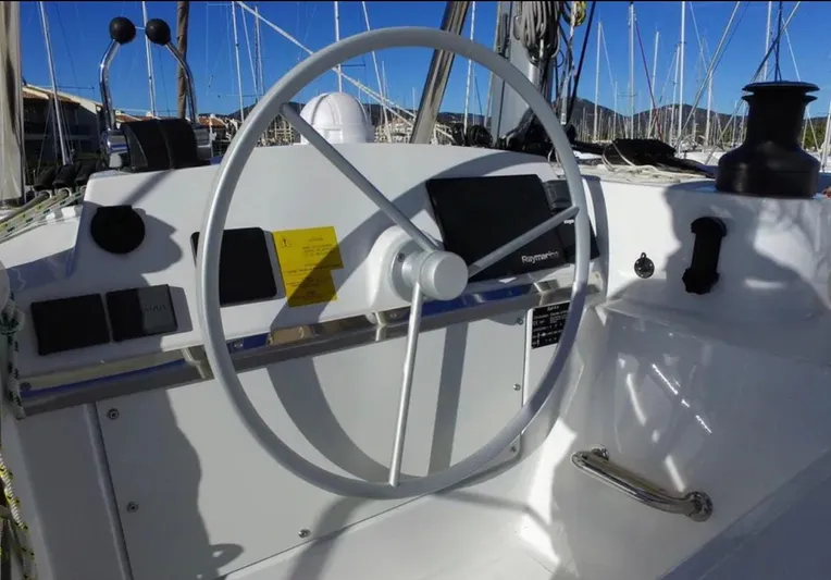  Yacht Photos Pics Steering wheel of 2023 Bali 4.4 yacht with navigation instruments, docked at marina.