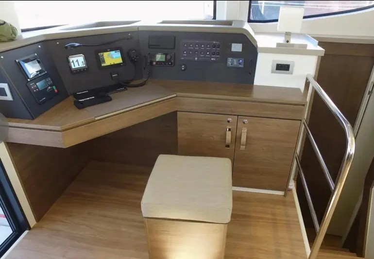  Yacht Photos Pics Modern helm station of 2023 Bali 4.4 yacht with navigation equipment and wooden finish.
