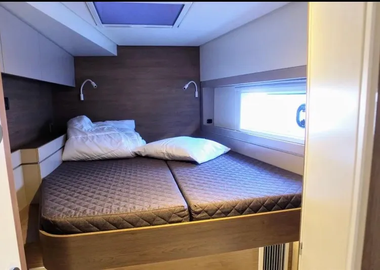  Yacht Photos Pics Modern cabin interior of 2023 Bali 4.4 yacht with cozy bed and window view.