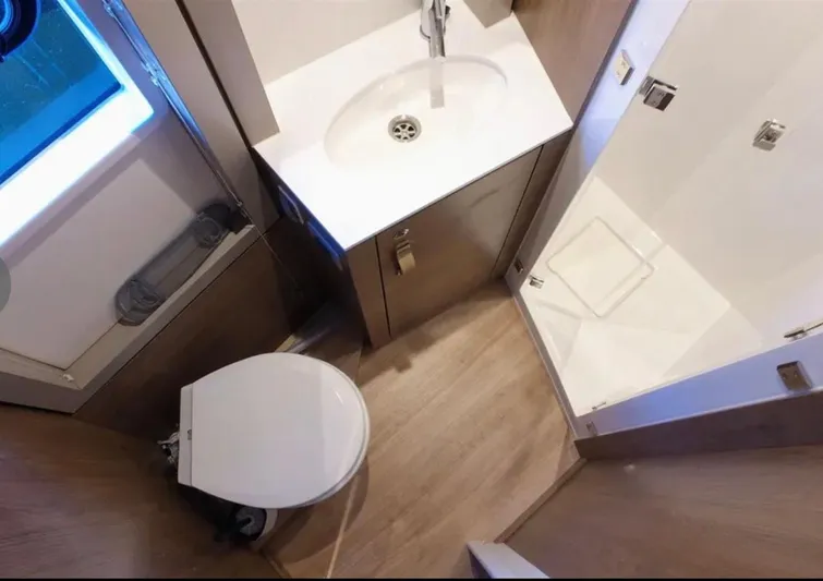  Yacht Photos Pics Compact bathroom in 2023 Bali 4.4 model with shower, sink, and toilet.