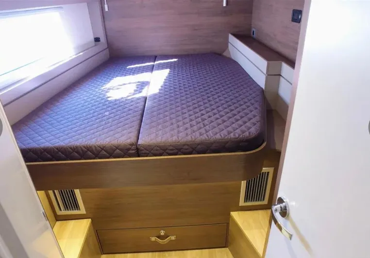 Yacht Photos Pics Modern bedroom in 2023 Bali 4.4 model yacht with quilted mattress and wooden storage.