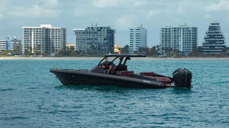  Yacht Photos Pics 2023 Skipper-BSK 42NC boat on water with city skyline in background.