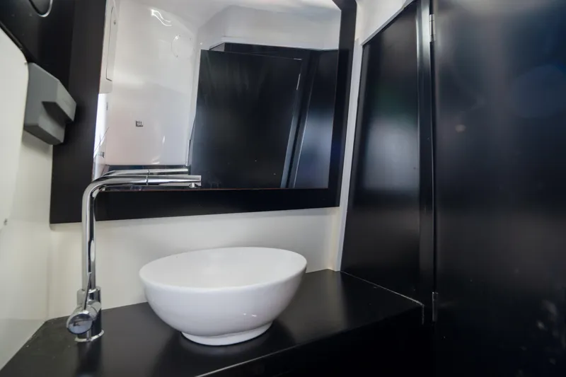  Yacht Photos Pics Modern bathroom interior in 2023 Skipper-BSK 42NC yacht with sleek sink and mirror.