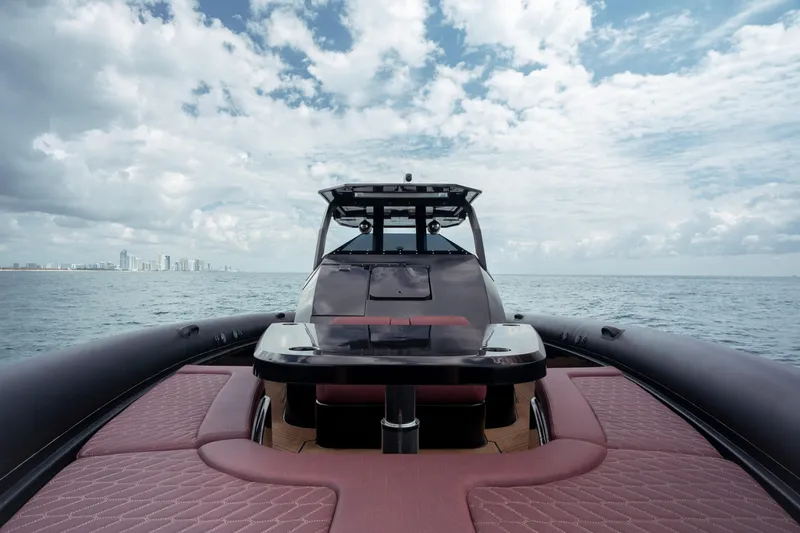  Yacht Photos Pics 2023 Skipper-BSK 42NC luxury boat on open sea with city skyline.