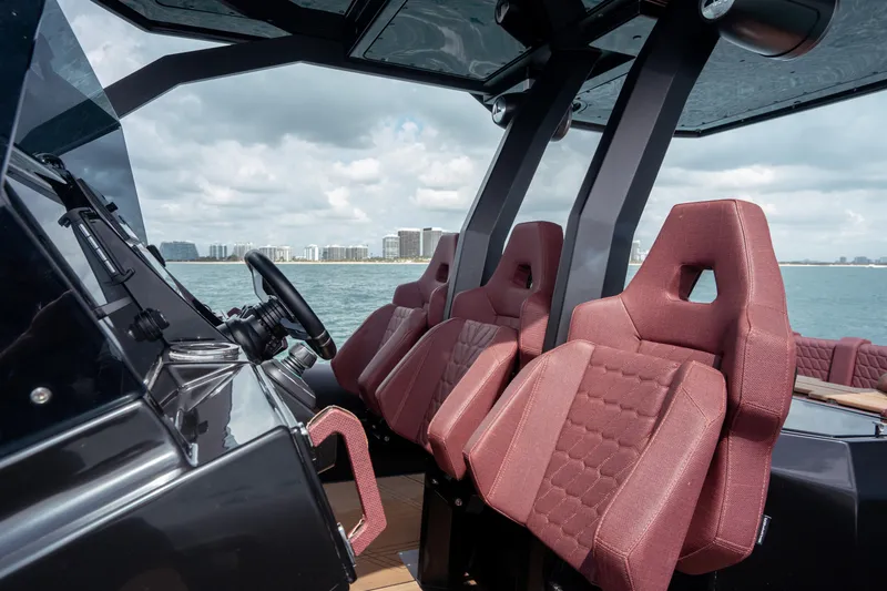  Yacht Photos Pics Luxurious interior of 2023 Skipper-BSK 42NC boat with red seats and modern design.