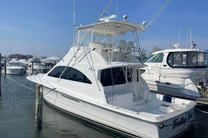 Trolling Fever Yacht Photos Pics 2005 Ocean Yachts 46 Super Sport docked at marina under clear blue sky.
