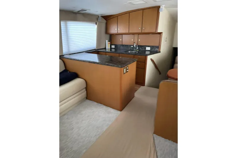 Trolling Fever Yacht Photos Pics Interior of 2005 Ocean Yachts 46 Super Sport with modern kitchen and seating area.