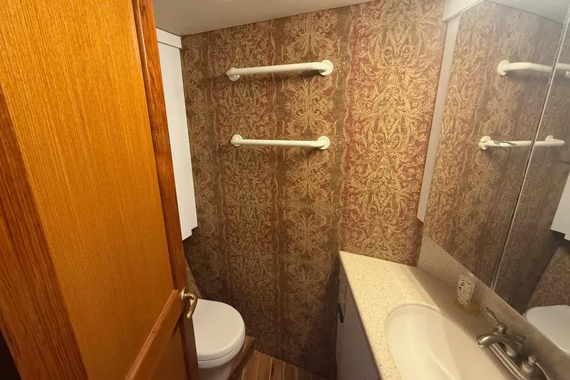Trolling Fever Yacht Photos Pics Bathroom interior of 2005 Ocean Yachts 46 Super Sport with ornate wallpaper and countertop sink.