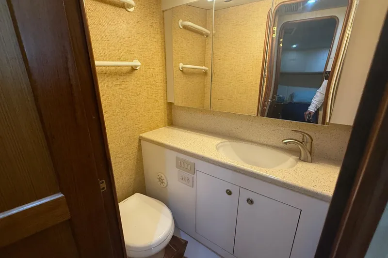 Trolling Fever Yacht Photos Pics Bathroom interior of 2005 Ocean Yachts 46 Super Sport, featuring sink and toilet.