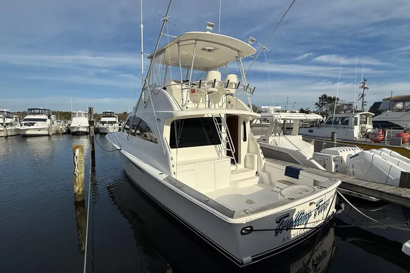 Trolling Fever Yacht Photos Pics 2005 Ocean Yachts 46 Super Sport docked at marina under clear sky.