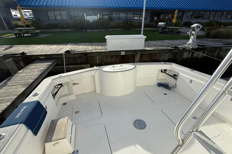 Trolling Fever Yacht Photos Pics 2005 Ocean Yachts 46 Super Sport boat deck at marina, featuring spacious seating and storage.