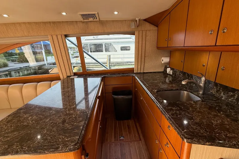 Trolling Fever Yacht Photos Pics Luxurious 2005 Ocean Yachts 46 Super Sport galley with marble countertops and wood cabinetry.
