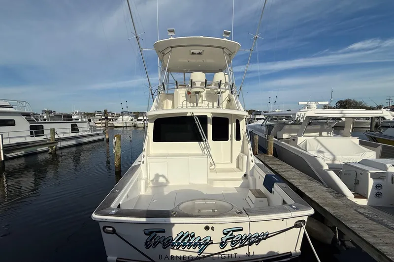 Trolling Fever Yacht Photos Pics 2005 Ocean Yachts 46 Super Sport docked at marina under clear sky.