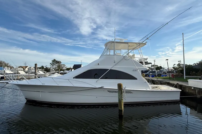 Trolling Fever Yacht Photos Pics 2005 Ocean Yachts 46 Super Sport docked at marina under blue sky.