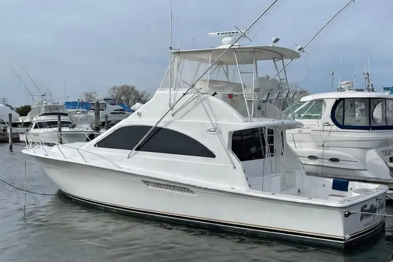 Trolling Fever Yacht Photos Pics 2005 Ocean Yachts 46 Super Sport docked in marina, side view.