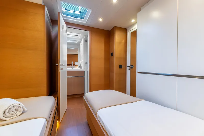 Cloudy Night Yacht Photos Pics Luxurious interior of 2019 CNB 76 yacht cabin with modern design and twin beds.