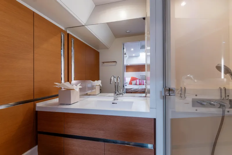 Cloudy Night Yacht Photos Pics Luxurious bathroom interior of 2019 CNB 76 yacht with modern fixtures and wood accents.