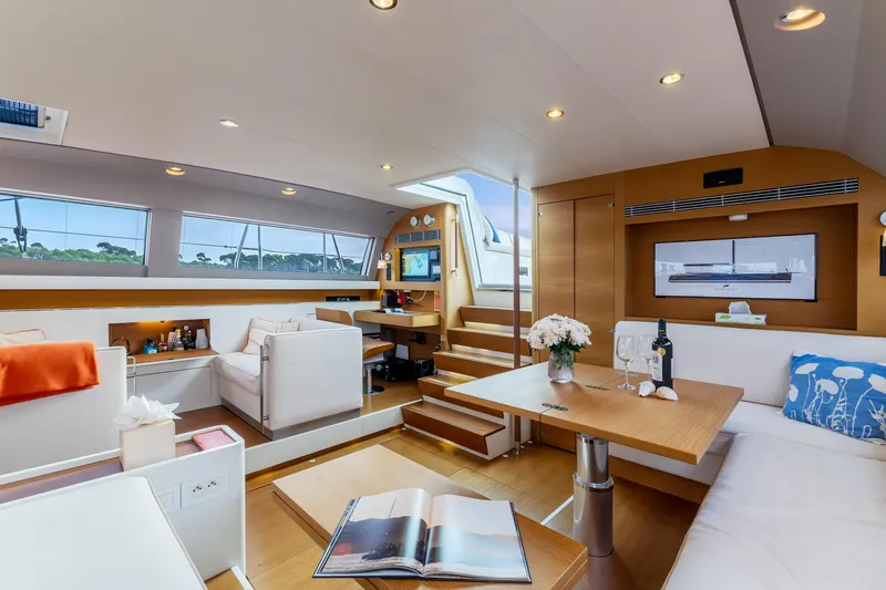 Cloudy Night Yacht Photos Pics Luxurious interior of 2019 CNB 76 yacht with elegant seating and dining area.