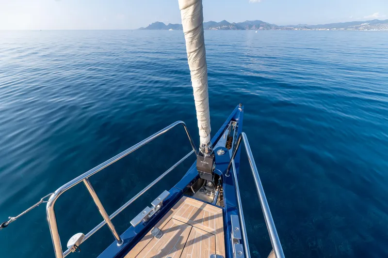 Cloudy Night Yacht Photos Pics Bow of CNB 76 yacht, 2019 model, sailing on calm blue sea.