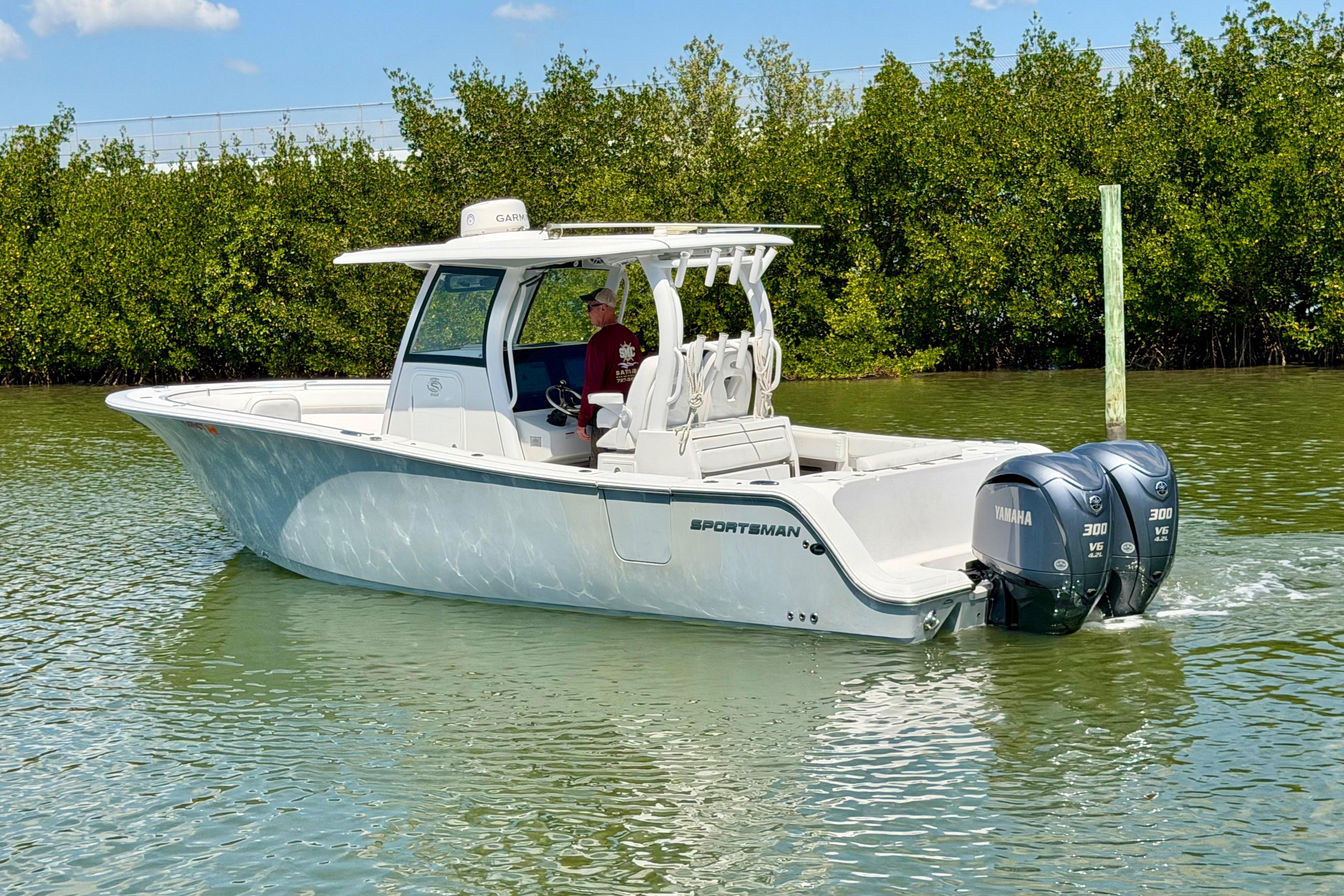 2021 Sportsman Open 302 Center Console boat on calm water with twin Yamaha engines.