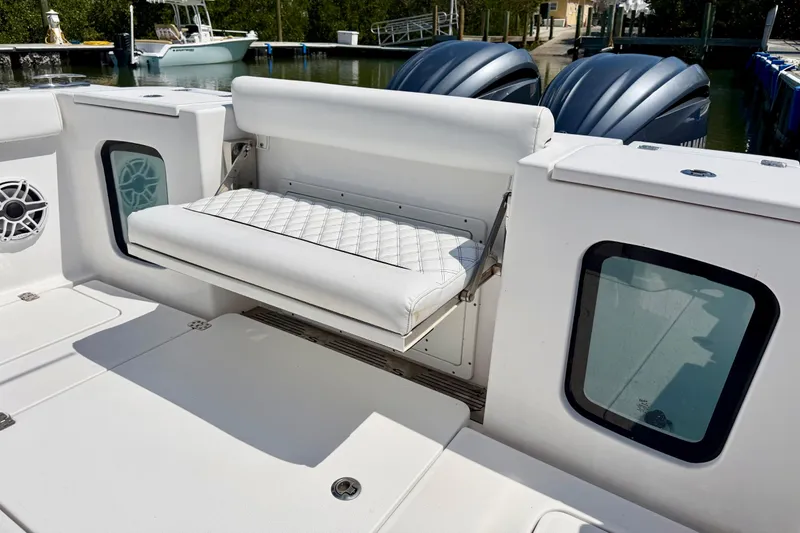  Yacht Photos Pics 2021 Sportsman Open 302 Center Console with foldable seat and twin engines at dock.