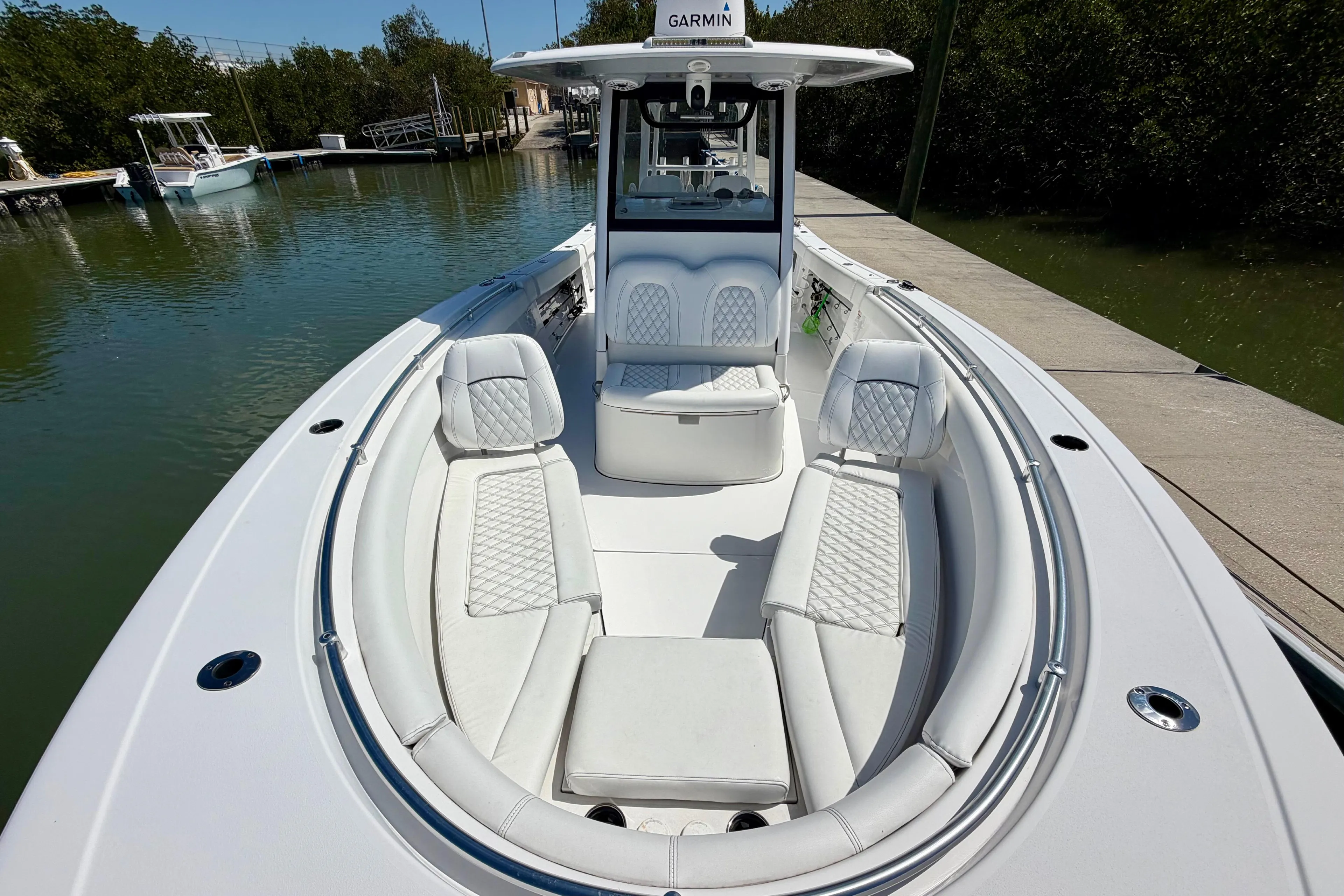 2021 Sportsman Open 302 Center Console boat with luxurious seating at a dock.