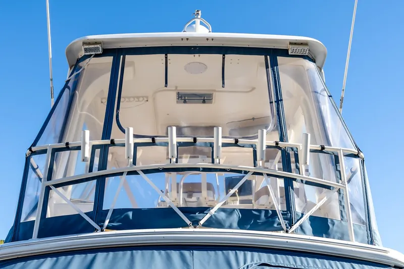 Falcon Yacht Photos Pics 1998 Ocean Yachts 48 Super Sport boat with clear enclosure and rod holders, under blue sky.